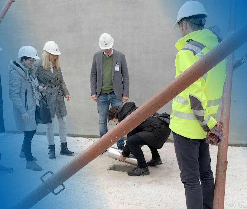 Kroop Leitgedanke Zeitkapsel-Legung Menschen mit Bauhelmen