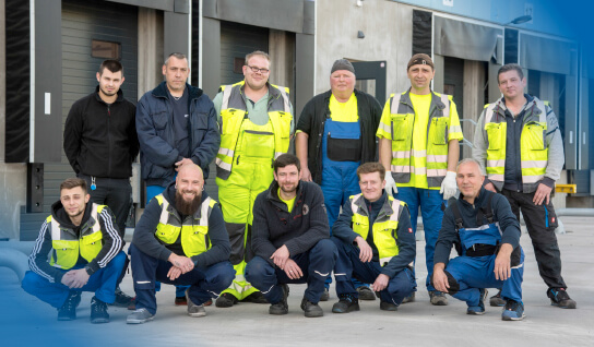 Warehouse workers group picture with safety vests